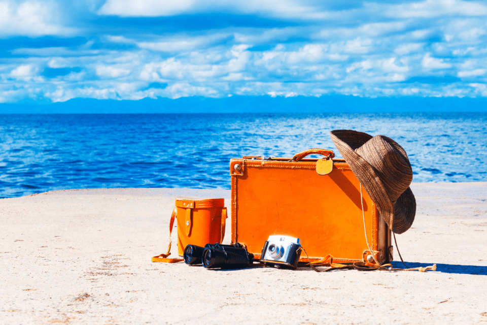 Orange luggage on the beach